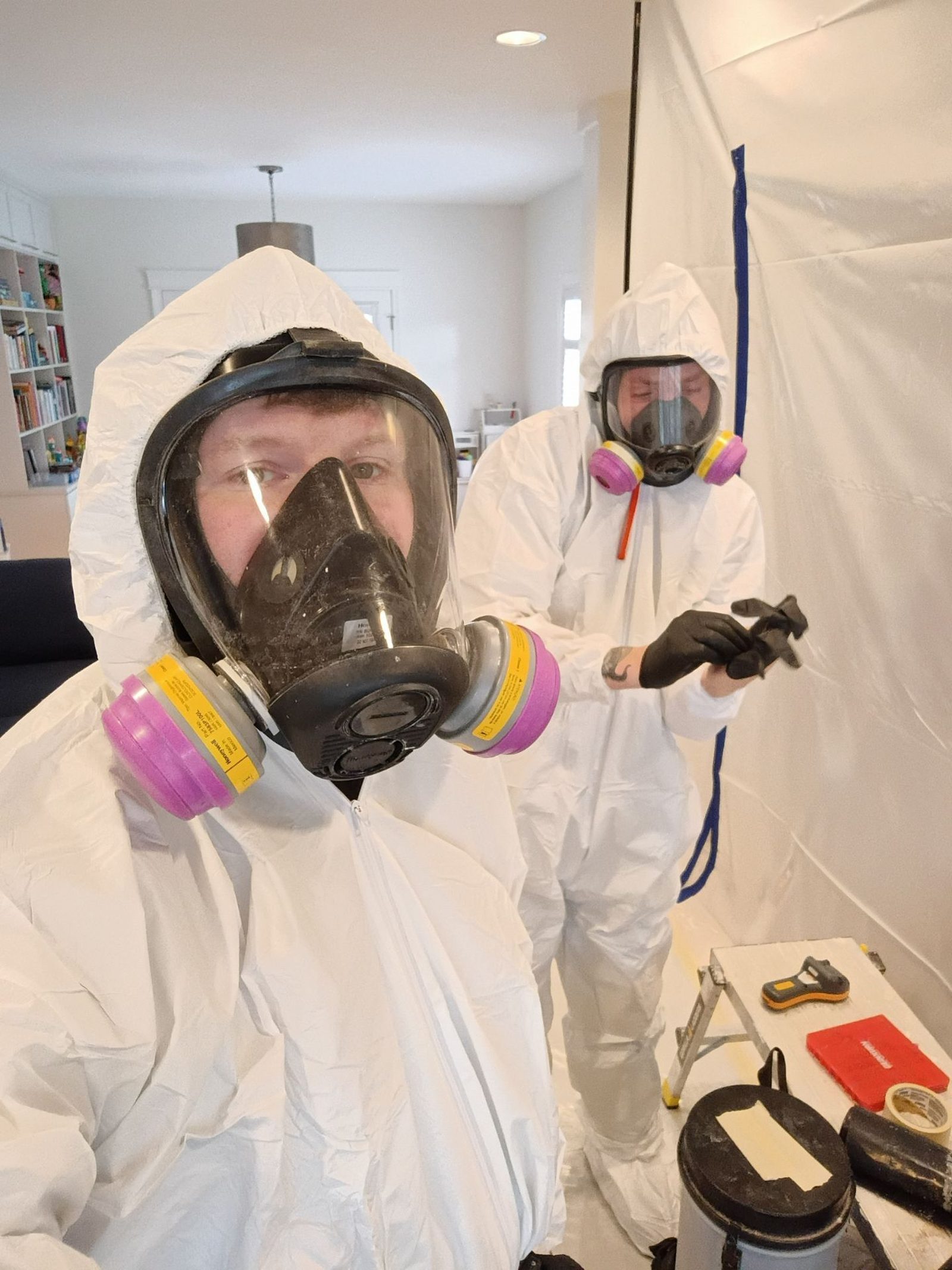 Lone Star Restoration technicians in protective equipment setting up containment in an East Dallas home